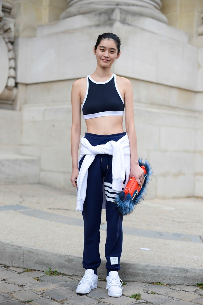 PARIS, FRANCE - JULY 08: Model Ming Xi poses wearing Thom Browne pants, Nike Jordan sneakers and Fendi bag after Chanel show on July 8, 2014 in Paris, France. (Photo by Vanni Bassetti/Getty Images)
