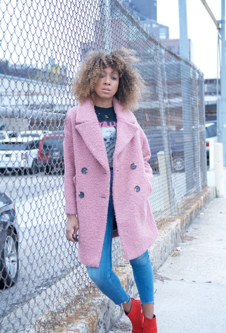 pink coat jeans band t-shirt outfit