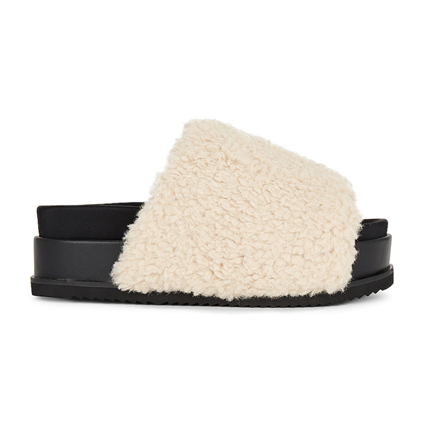 A platform slide lined with white bouclé fabric