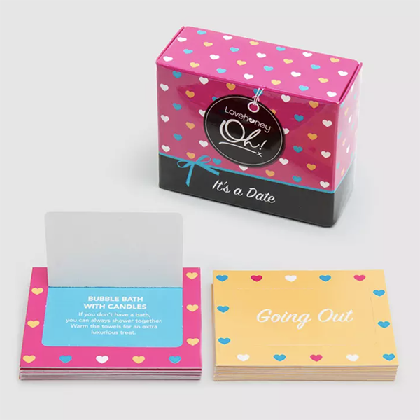 Two stacks of date night prompts in front of a date night card box