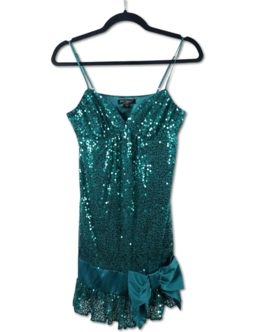 A vintage teal sequin Betsey Johnson dress on a hanger