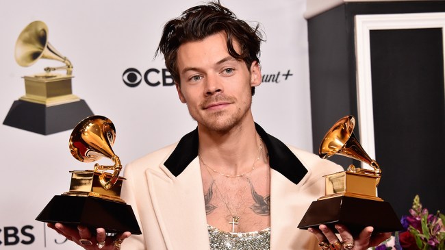 Harry Styles holding Grammys