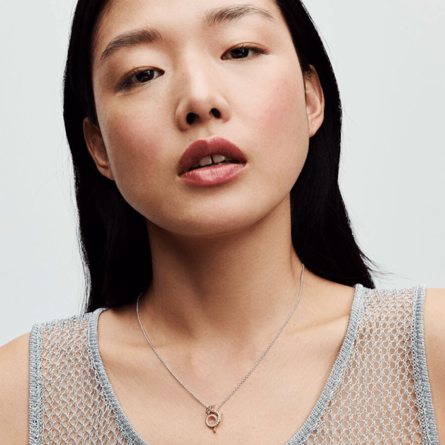 A model wearing a dragon necklace from Pandora