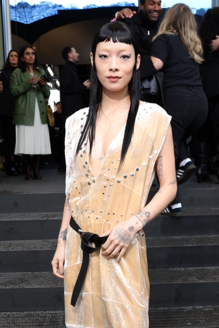 Rina Sawayama with long black hair and bleached brows at Milan Fashion Week.