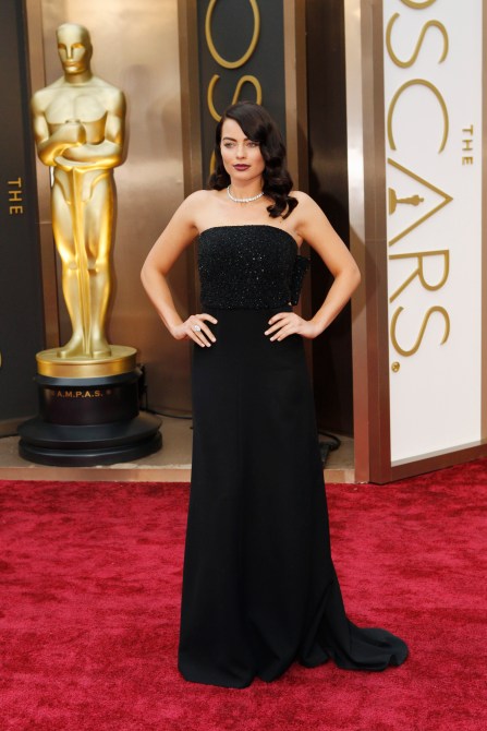 Margot Robbie wearing a sparkly black dress, her hair is dark brown.