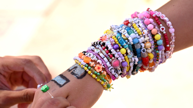 Taylor Swift fan wearing Eras Tour friendship braclets.