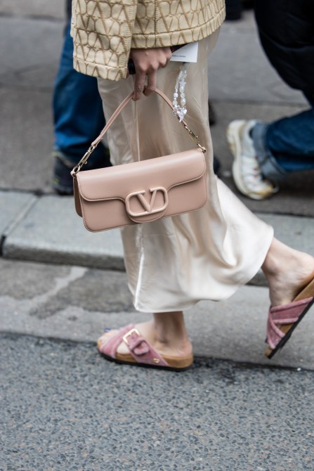 A guest at Paris Fashion Week wearing slide sandals.