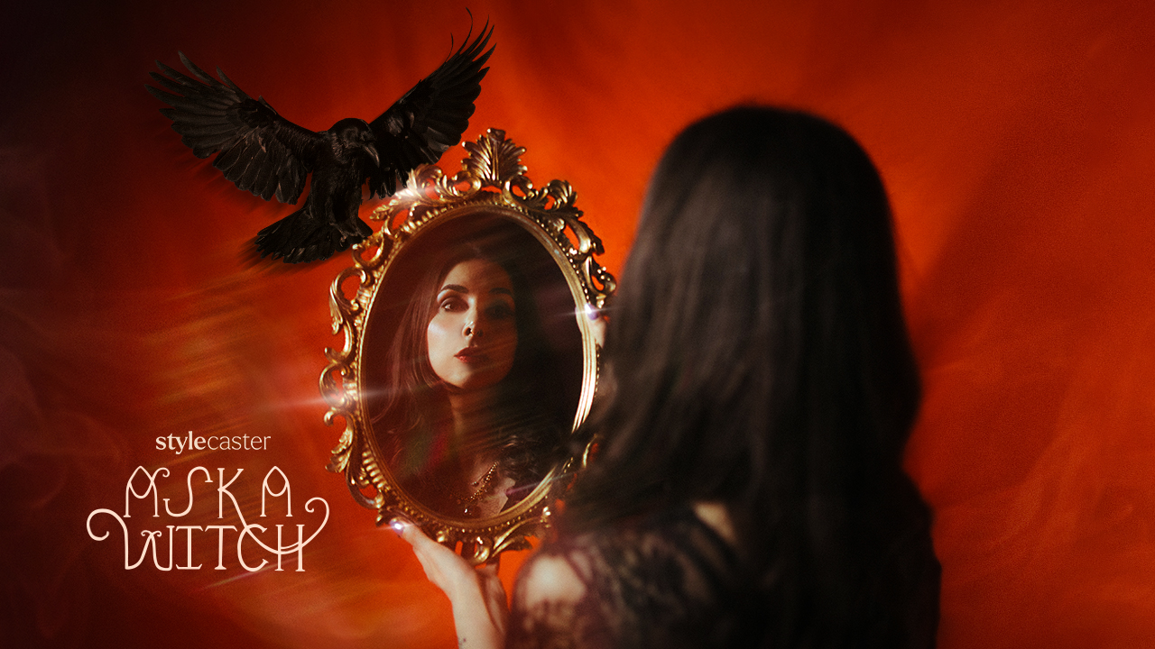 A witch woman looking at her reflection in an ornate mirror with a raven landing on top of it
