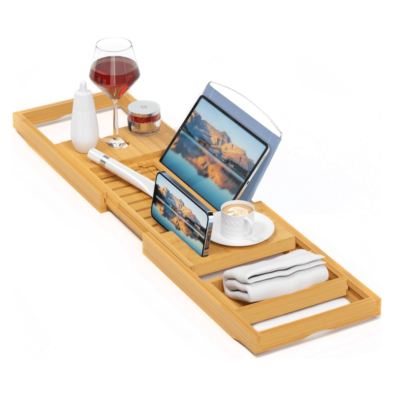 A wooden bath tray topped with wine, coffee, a tablet, a phone, and more