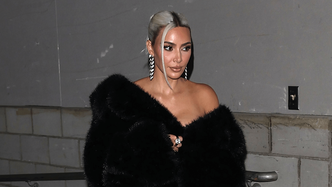 Kim Kardashian with platinum hair in a low bun.
