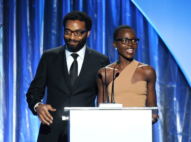 Chiwetel Ejiofor (L) and Lupita Nyong'o speak onstage during the 25th annual Producers Guild of America Awards at The Beverly Hilton Hotel on January 19, 2014 in Beverly Hills, California.