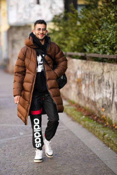 A fashion week guest wearing wire frame glasses.