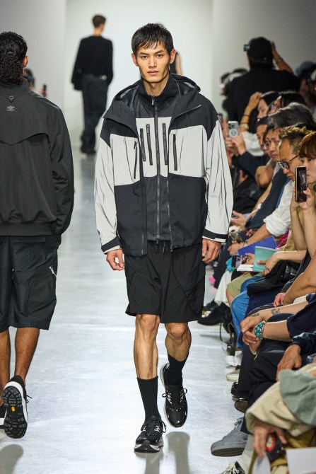 A model wearing a windbreaker.