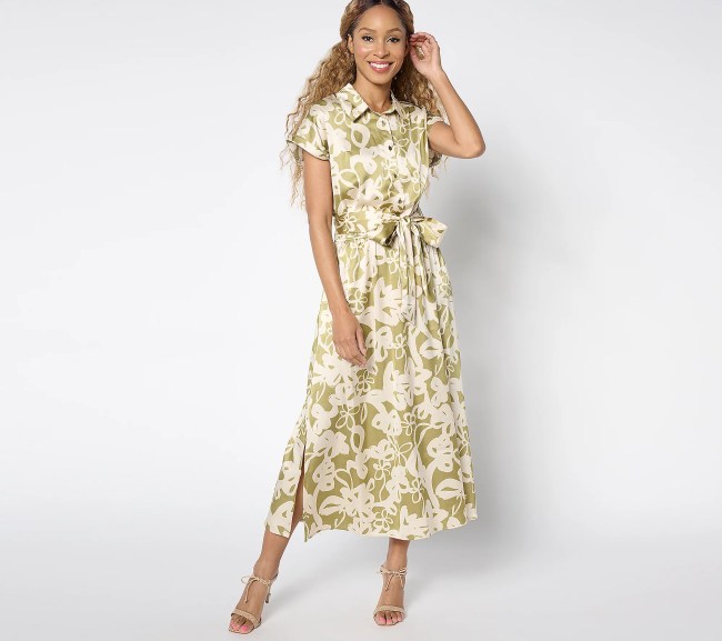 A model wearing the Susan Graver Charmeuse Midi Dress in a green and off-white floral pattern