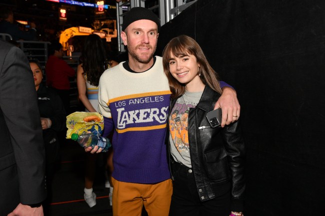 Lily Collins and Charlie McDowell attend a basketball game between the Los Angeles Lakers and the Golden State Warriors at Crypto.com Arena on February 23, 2023 in Los Angeles, California.