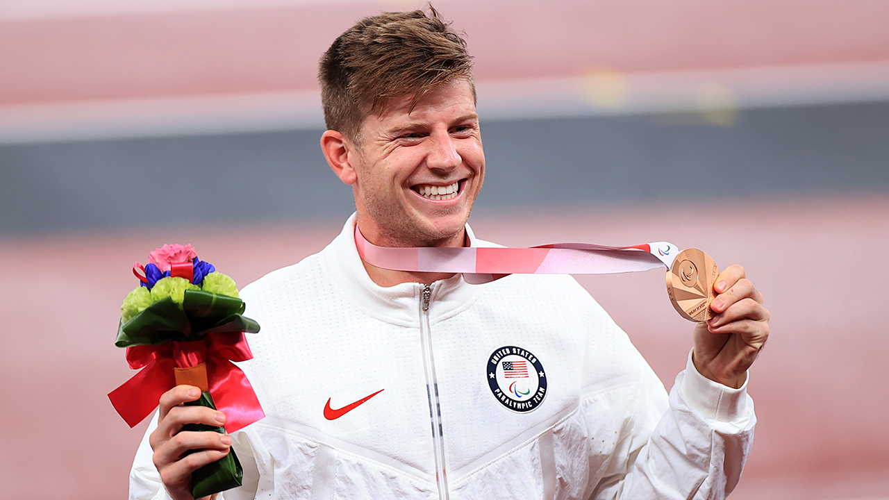 Bronze medalist Hunter Woodhall of Team United States poses on the podium at the medal ceremony for the Men's 400m - T62 on day 10 of the Tokyo 2020 Paralympic Games at the Olympic Stadium on September 03, 2021 in Tokyo, Japan.