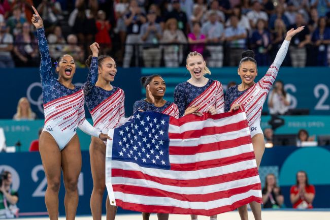 PARIS, FRANCE: JULY 30:  Jordan Chiles, Hezly Rivera, Simone Biles, Jade Carey and Sunisa Lee of the United States celebrate after the team's victory during the Artistic Gymnastics Team Final for Women at the Bercy Arena during the Paris 2024 Summer Olympic Games on July 30th, 2024 in Paris, France.