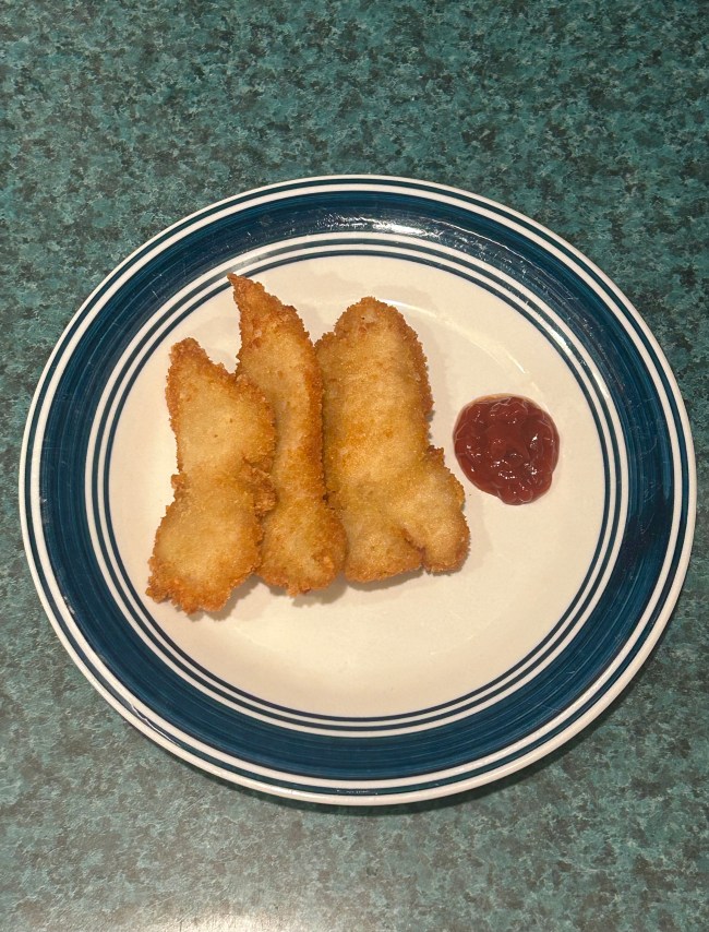 A plate with three chicken fingers