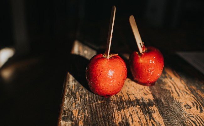 Two red candy apples with lollypop sticks