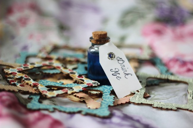 A vial of liquid with a label that reads "Drink Me"