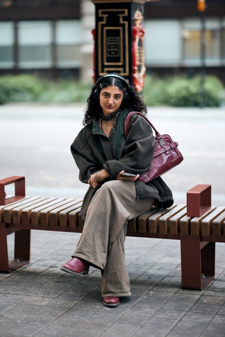 A fashion week guest with a red bag.