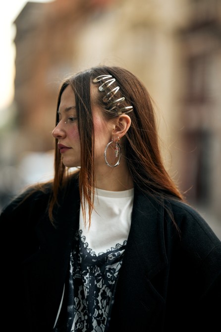 A fashion week guest wearing hair clips.