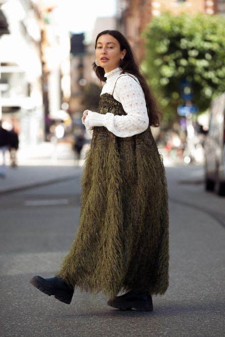 Cassandra Rasmussen Taleb wearing white long sleeve shirt and long army green Ganni dress during Stockholm fashion week Spring/Summer 2022 on August 31, 2021 in Stockholm, Sweden.