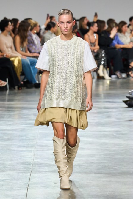 Model on Rabanne runway with scrunched up knee-length leather boots.