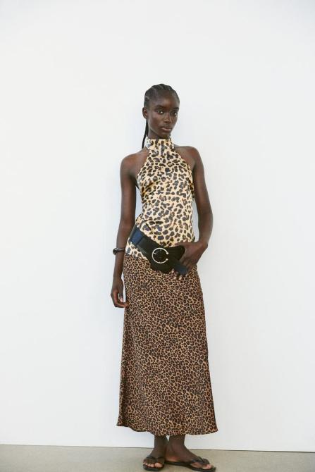 Model wears leopard print halter top.