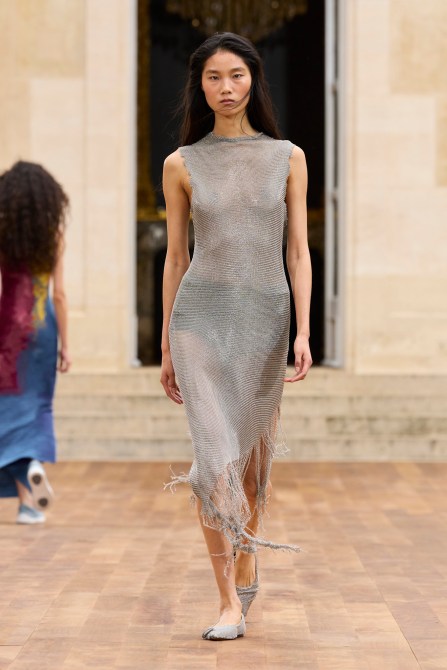 A model wearing a silver dress.