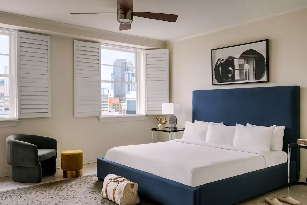 Bedroom with two windows and various furnishings