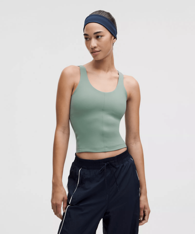 A model wearing the Lululemon Glow Up Tank Top Medium Support, B/C Cup in a seafoam green colorway