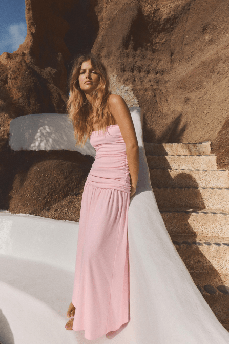 A model wearing the Zara Ruched Strapless Dress in pastel pink
