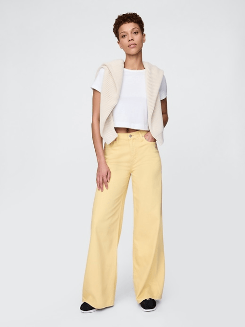 A model wearing the GAP Mid Rise UltraSoft Baggy Jeans in light yellow