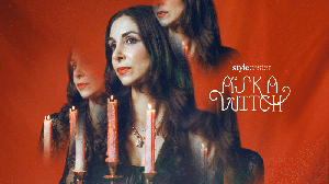Ask a Witch advice columnist Roya Backlund holding a candelabra in a floating gif