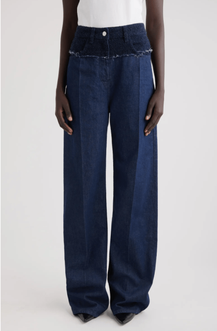 A model wearing the Givenchy Big Mix Bouclé Yoke Jeans in indigo blue colorway