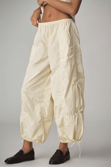 A model wearing the Daily Practice The Bowline Parachute Pants in very light yellow