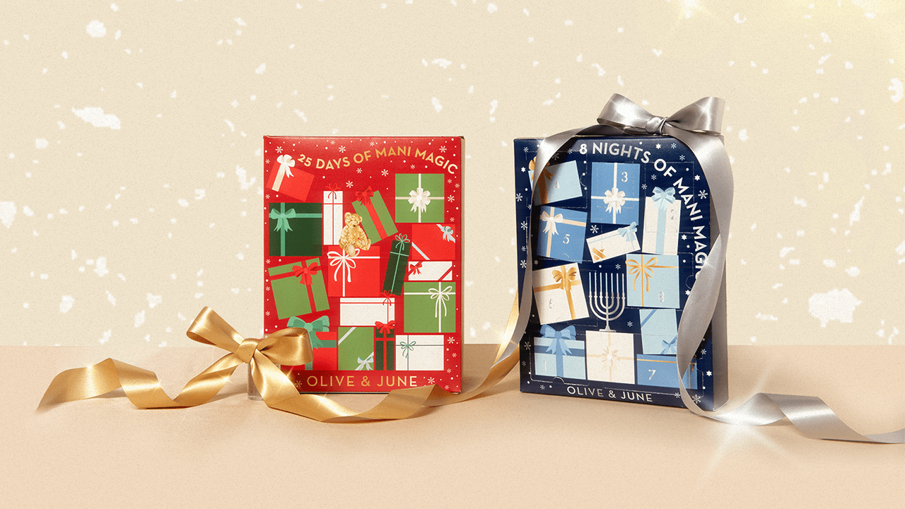 Two Olive & June advent calendars next to each other with ribbons