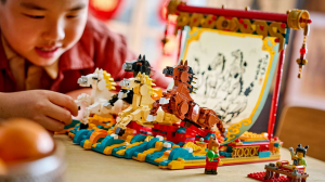 A little boy playing with a LEGO Lunar New Year Year of the Horse galloping horse set