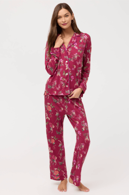 A woman in pink floral pajamas